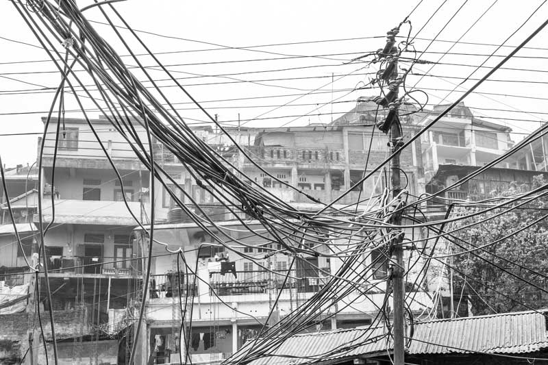 In the absence of proper supporting structures, water cables bringing water from hill springs and streams in Kohima, Nagaland are laid over telephone and electricity poles along the roads